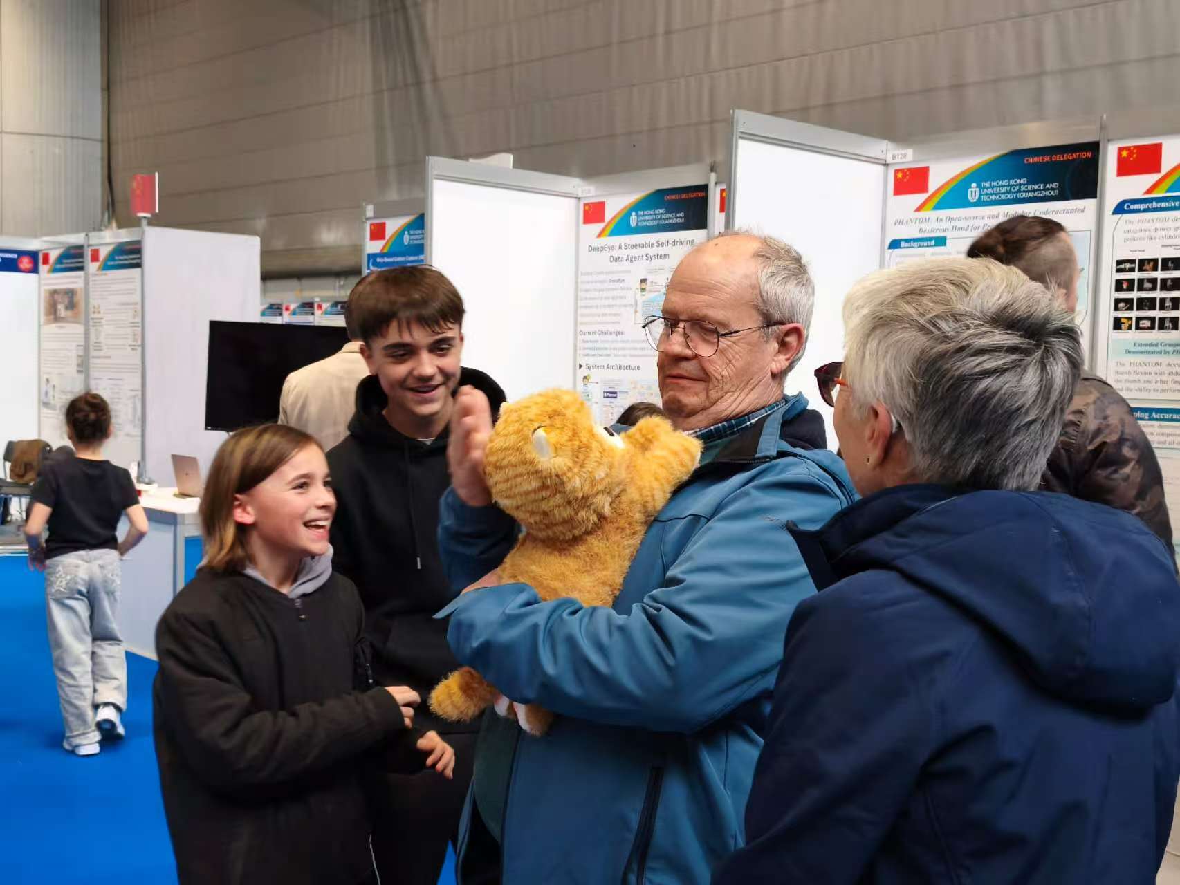 A visitor interacting with the Lumi Cat prototype at an exhibition.